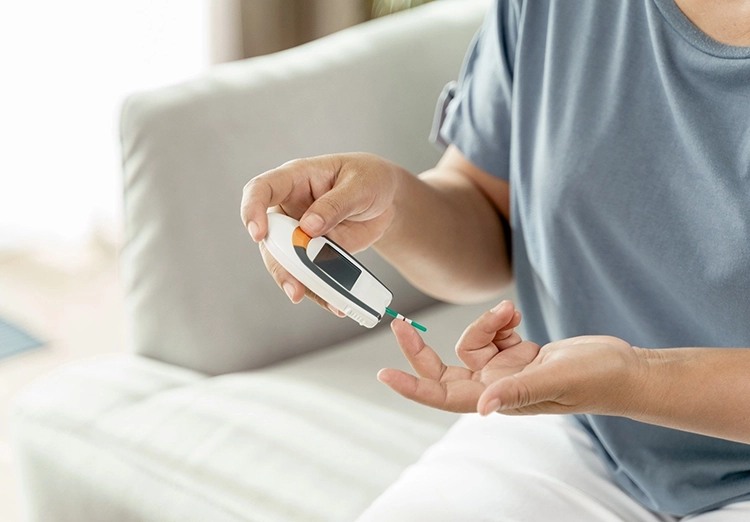 A diabetic patient is testing blood sugar.