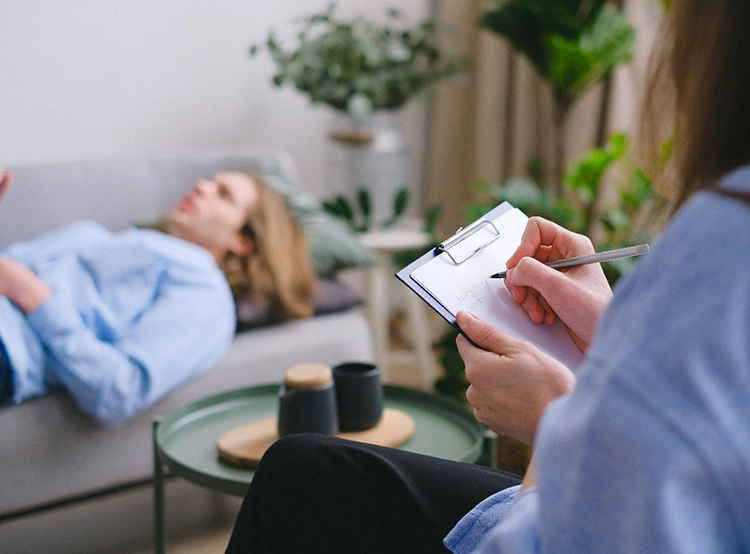 She lay on the sofa to relax, and the doctor recorded her data beside her