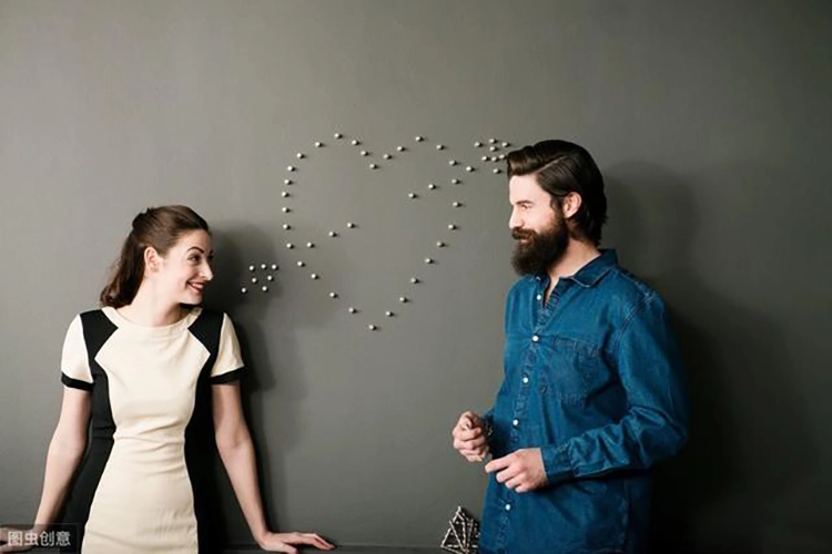 Couples look at each other on both sides of the heart-shaped pattern