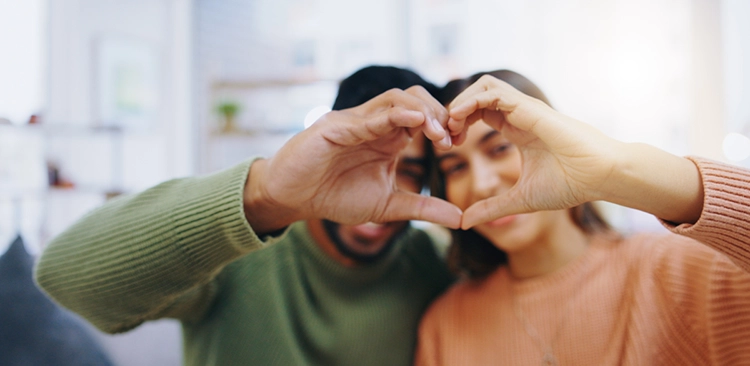 The couple made a heart gesture to the camera