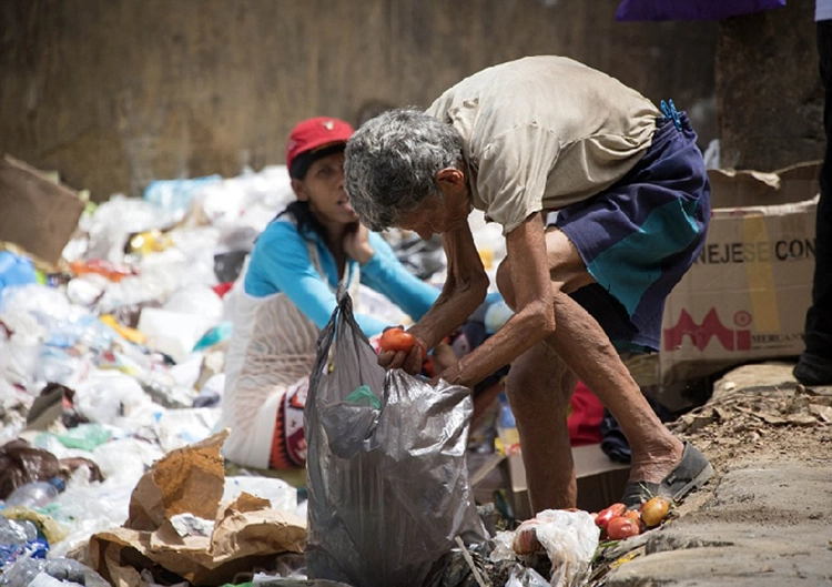 He looked for something useful in the garbage.