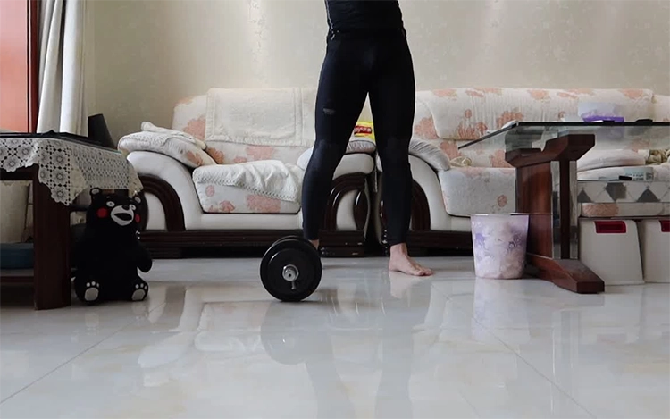 She is preparing to exercise with dumbbells at home.