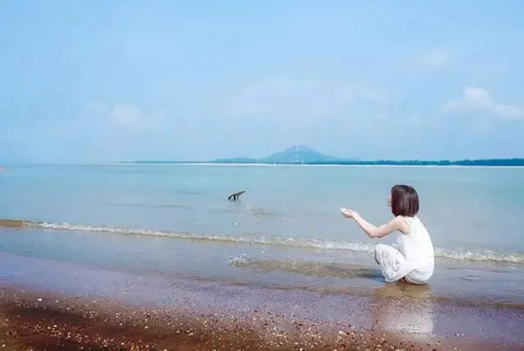 She relaxes herself on the beautiful beach