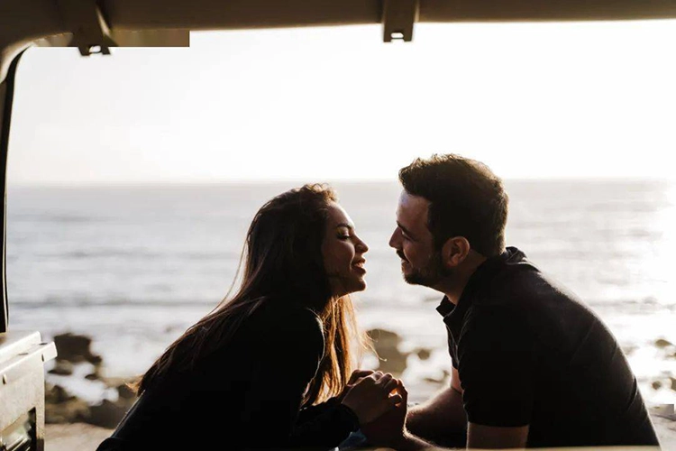 Couples prepare to kiss at the beach