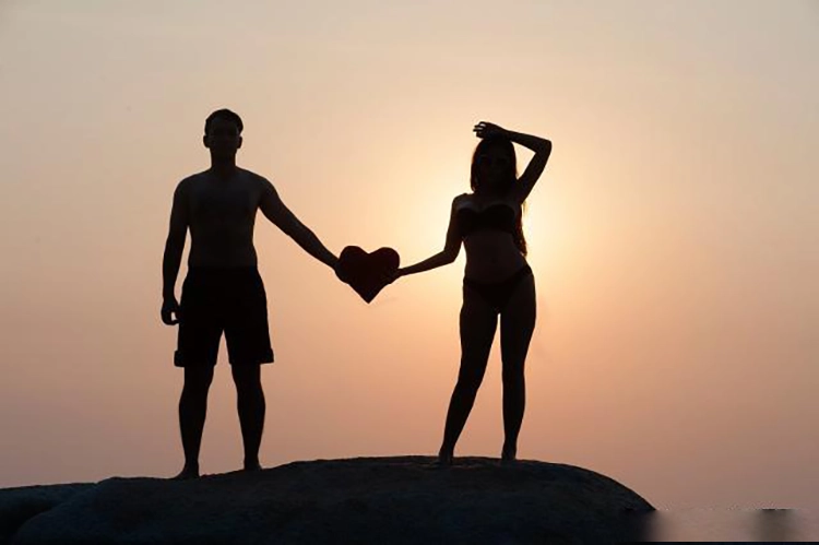 Couples looking at the sunset with love