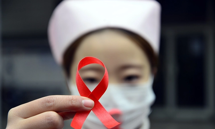 The nurse used a red rope to lay out the AIDS Association logo.