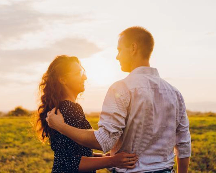 Couples look at each other in the sunset