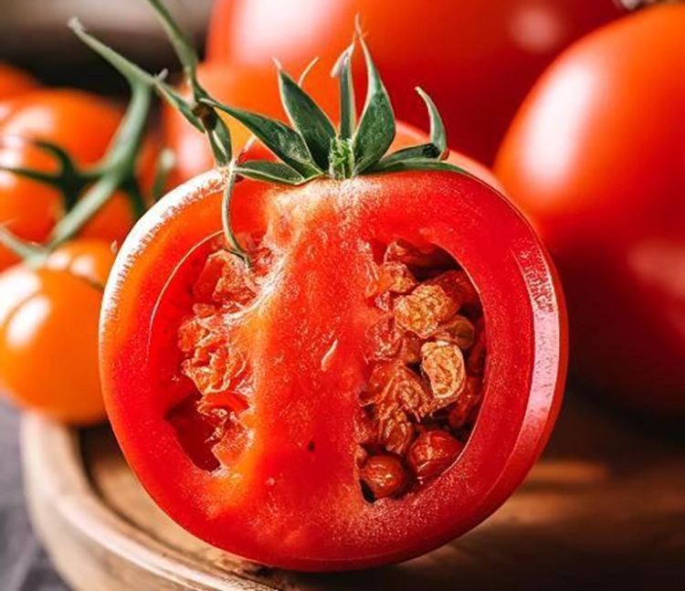 A very fresh tomato cut in half.