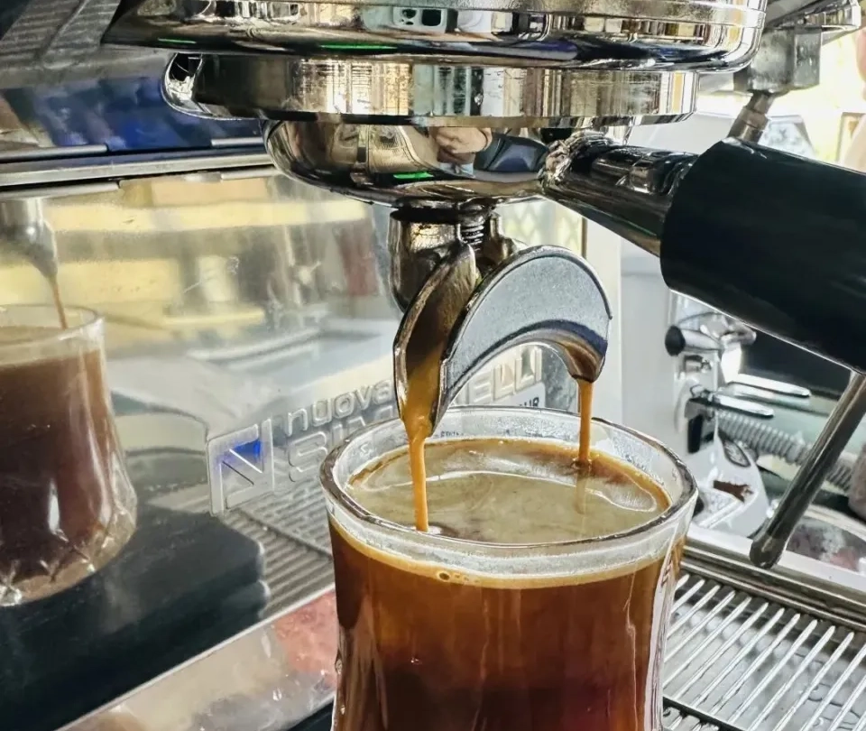 The fully automatic coffee machine is extracting coffee.