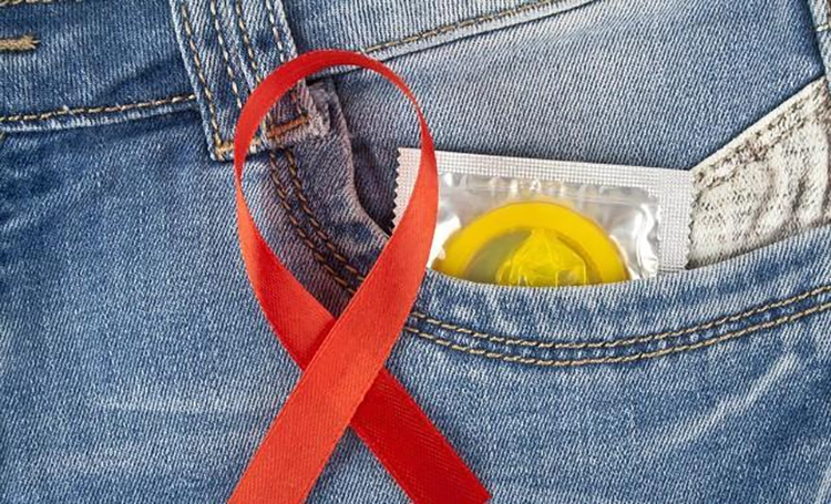 Condoms and the AIDS Association logo are placed in the pocket of jeans.